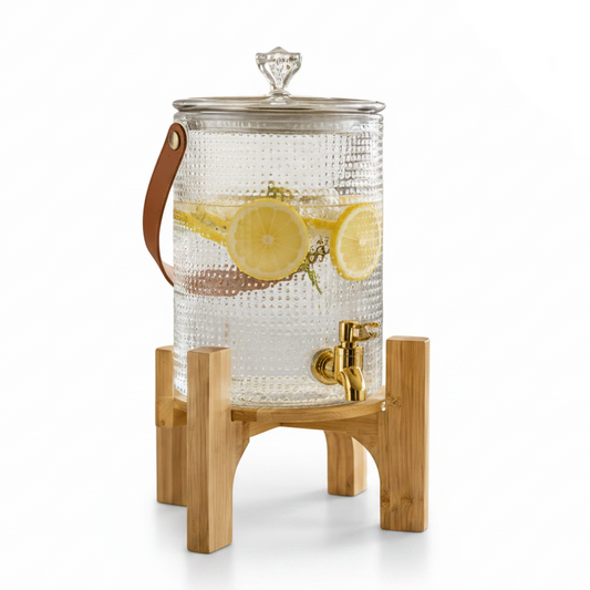 Decency luxury glass drink dispenser with a polished wooden base and elegant gold tap placed on a modern kitchen counter.