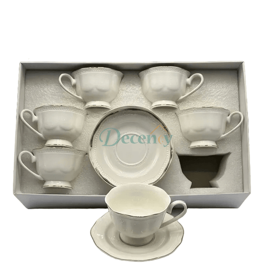 Elegant 6-piece tea cups and saucers set featuring a detailed embossed design and a classic silver rim.