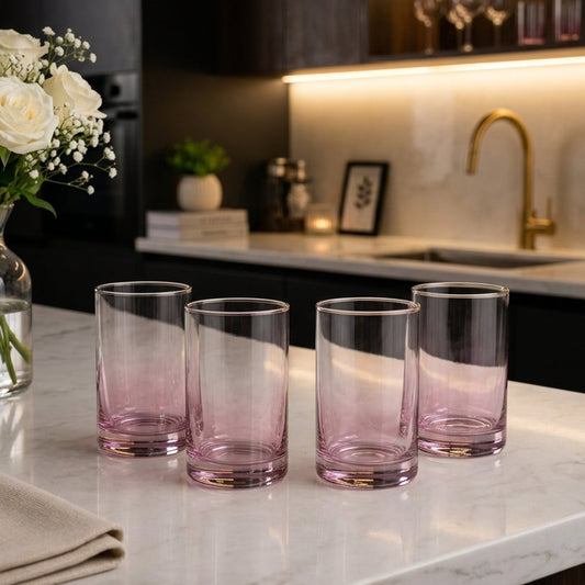 Elegant 4-piece pink gradient glass tumbler set displayed on a marble countertop