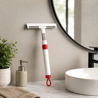 Person using extendable window squeegee wiper to clean a wet glass window