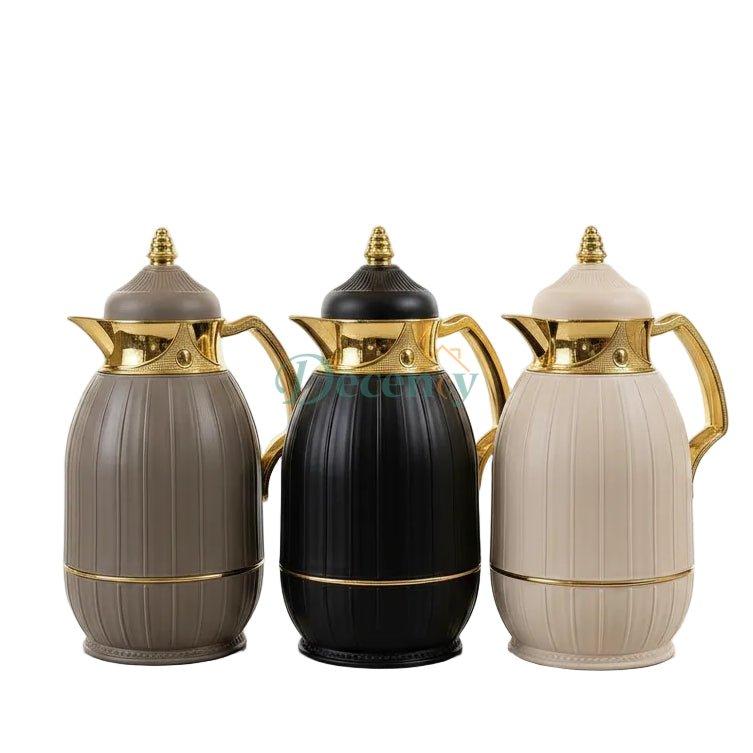 Trio of Feenik 1 litre vacuum flasks in grey, black, and cream with gold trim on a marble countertop