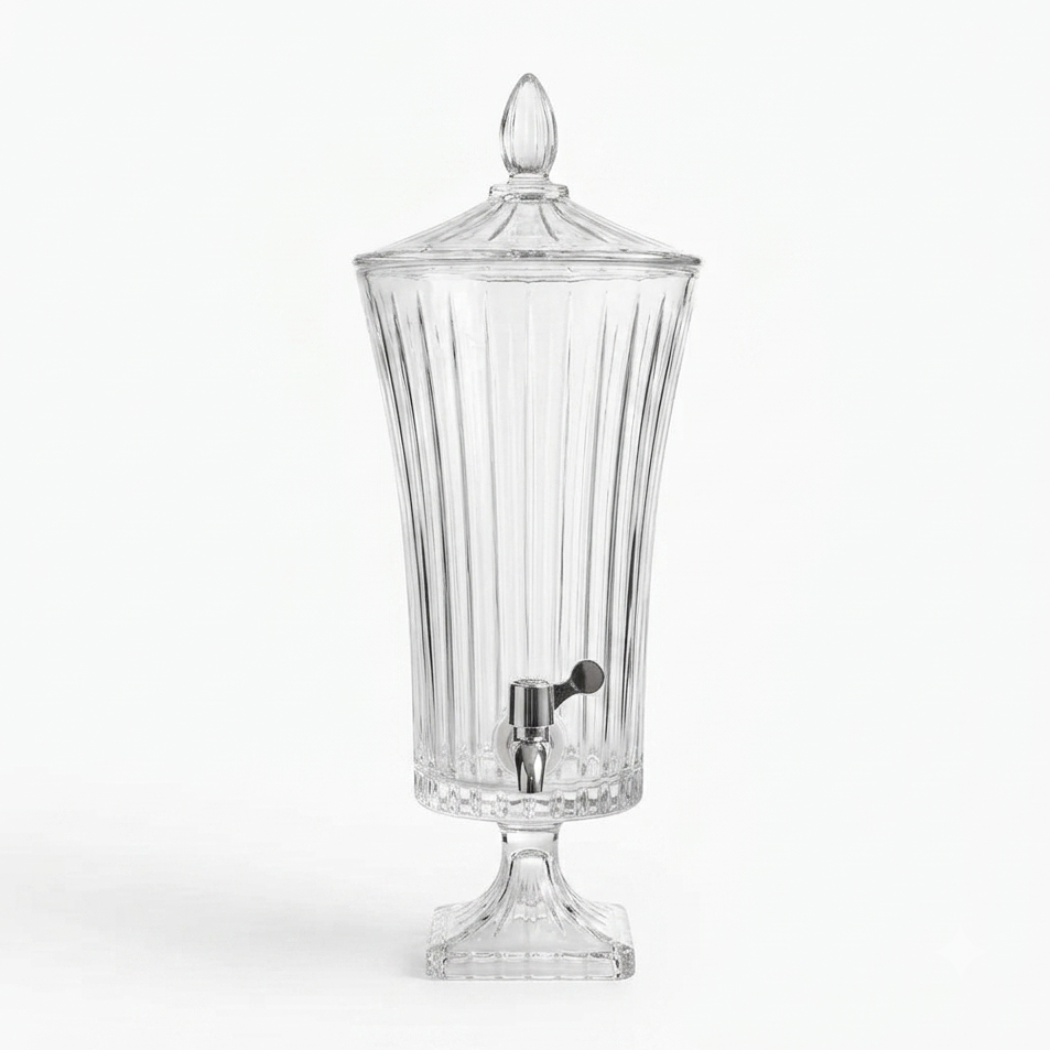 Tall 4.5L fluted glass beverage dispenser with a chrome tap set on a dining table setup.