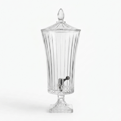 Tall 4.5L fluted glass beverage dispenser with a chrome tap set on a dining table setup.