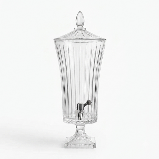Tall 4.5L fluted glass beverage dispenser with a chrome tap set on a dining table setup.