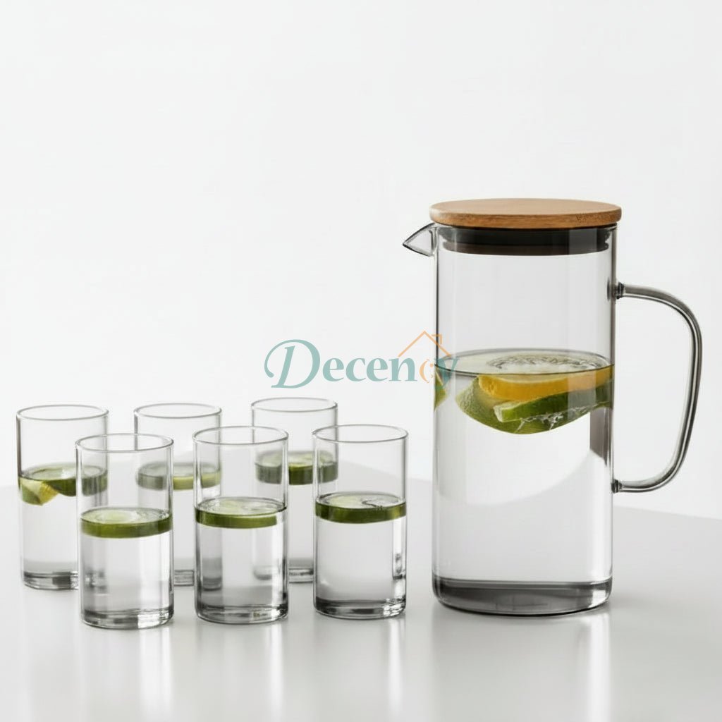 7-piece clear glass water jug set with wooden lid and 6 matching drinking glasses on a white table