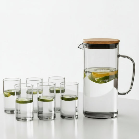 7-piece clear glass water jug set with wooden lid and 6 matching drinking glasses on a white table
