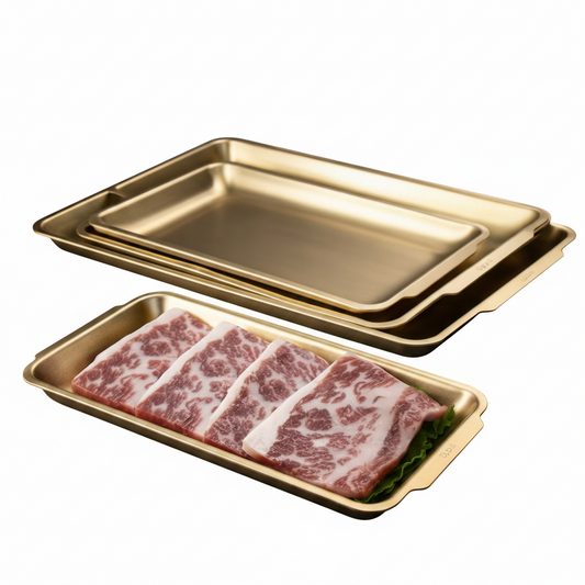 Luxury gold stainless steel serving tray set displayed on a marble kitchen countertop.