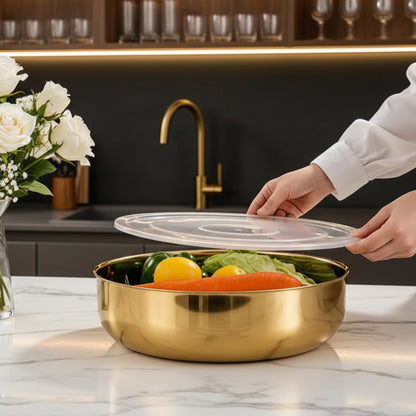 Golden stainless steel serving bowl with a transparent airtight lid held above it.