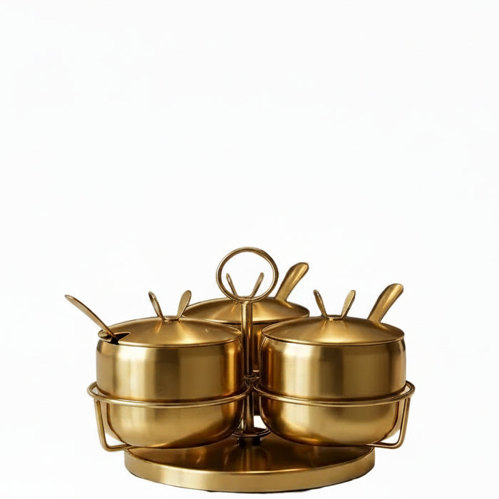 Golden stainless steel spice jar set placed on a 360-degree rotatable rack for kitchen countertops