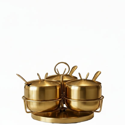 Golden stainless steel spice jar set placed on a 360-degree rotatable rack for kitchen countertops
