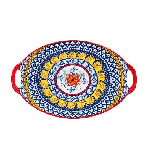 Top view of an oval handpainted ceramic serving platter with vibrant blue, yellow, and red floral designs.