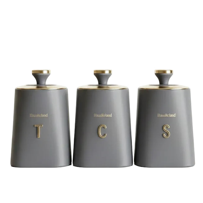 Haus Roland grey ceramic style canister set featuring elegant gold caps and gold T C S letters