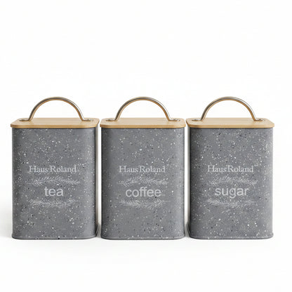 Haus Roland set of 3 grey speckled tea coffee sugar canisters with bamboo lids on a marble countertop