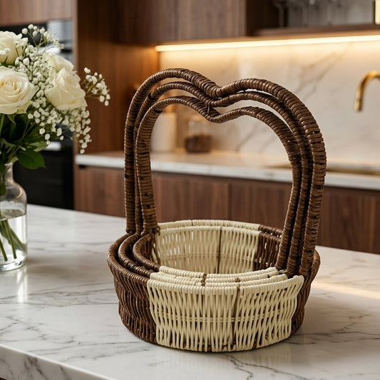Heart-shape woven rattan basket set displayed on a modern marble kitchen counter.