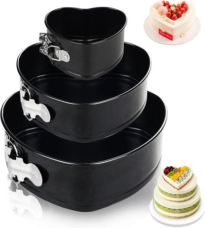 Set of three black tiered cake pans with a small cake on a white background