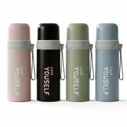 Four 300ml insulated stainless steel water bottles in pink, black, green, and blue on a kitchen counter