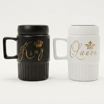 Black King and white Queen ceramic coffee mug set with gold calligraphy placed on a modern marble kitchen counter.