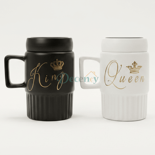 Black King and white Queen ceramic coffee mug set with gold calligraphy placed on a modern marble kitchen counter.