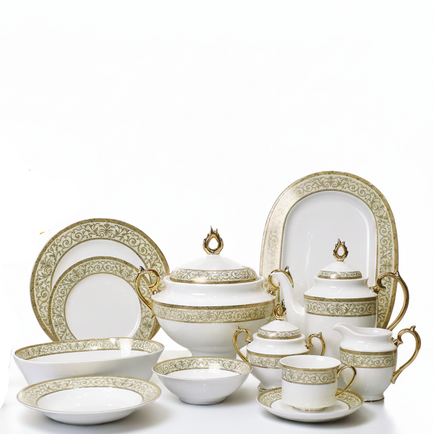 elegant gold filigree bone china dinner set arranged beautifully on a white table with a vase of yellow flowers.