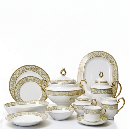 elegant gold filigree bone china dinner set arranged beautifully on a white table with a vase of yellow flowers.