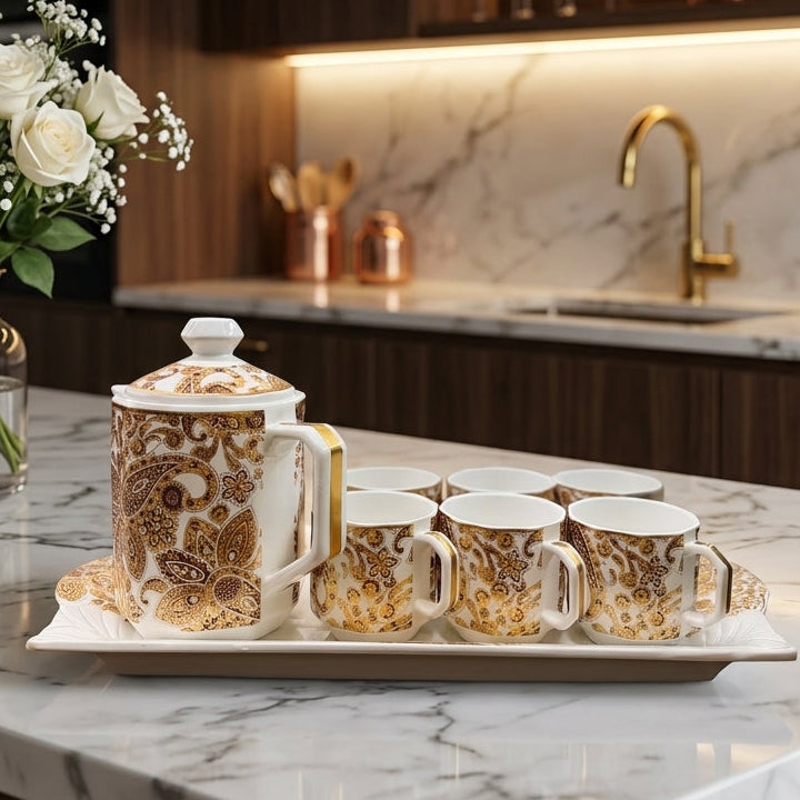 8 piece luxury golden ceramic tea set with teapot, 6 cups, and serving tray on a marble countertop