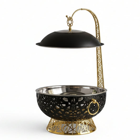 Black and gold luxury 8L food warmer chafing dish placed on a marble kitchen countertop.