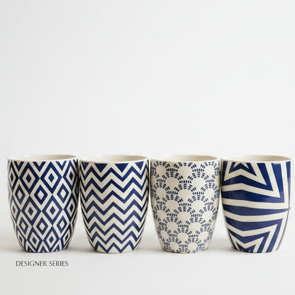 Single luxury blue and white printed ceramic mug displayed on a marble countertop.