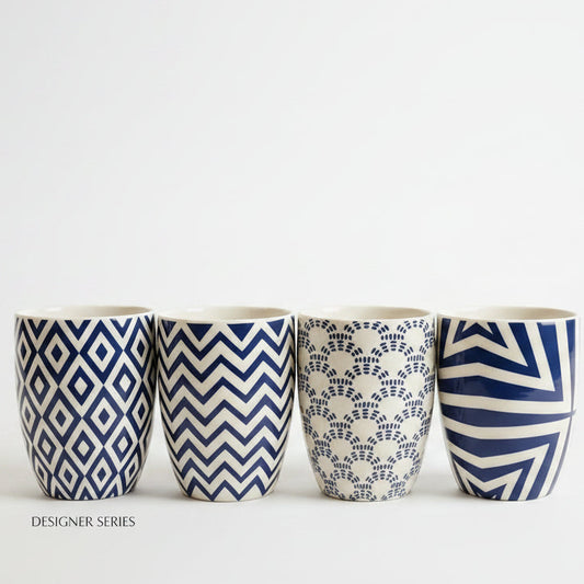 Single luxury blue and white printed ceramic mug displayed on a marble countertop.