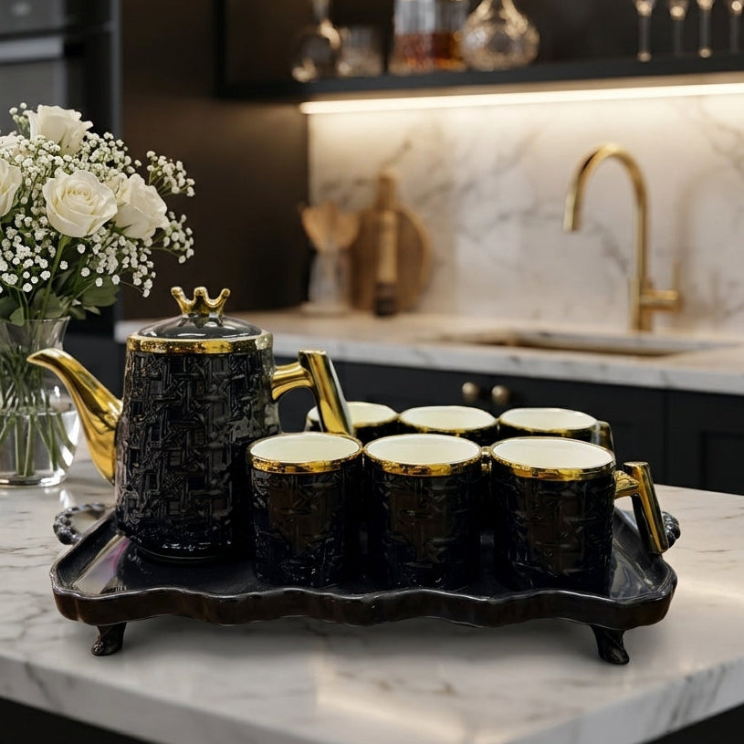 8-piece black and gold luxury ceramic tea set placed on a marble kitchen island