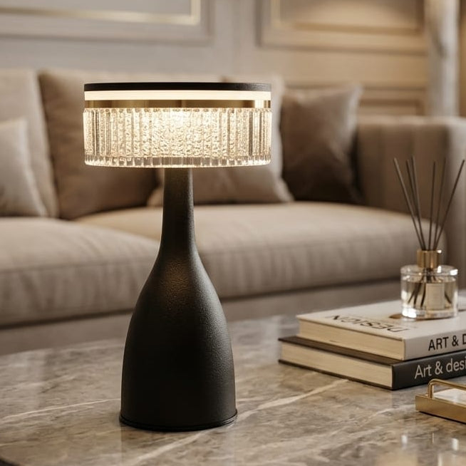Modern black cordless table lamp with textured crystal shade on a marble coffee table in a living room