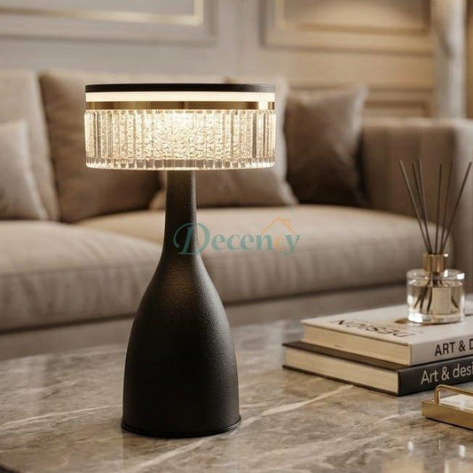 Modern black cordless table lamp with textured crystal shade on a marble coffee table in a living room