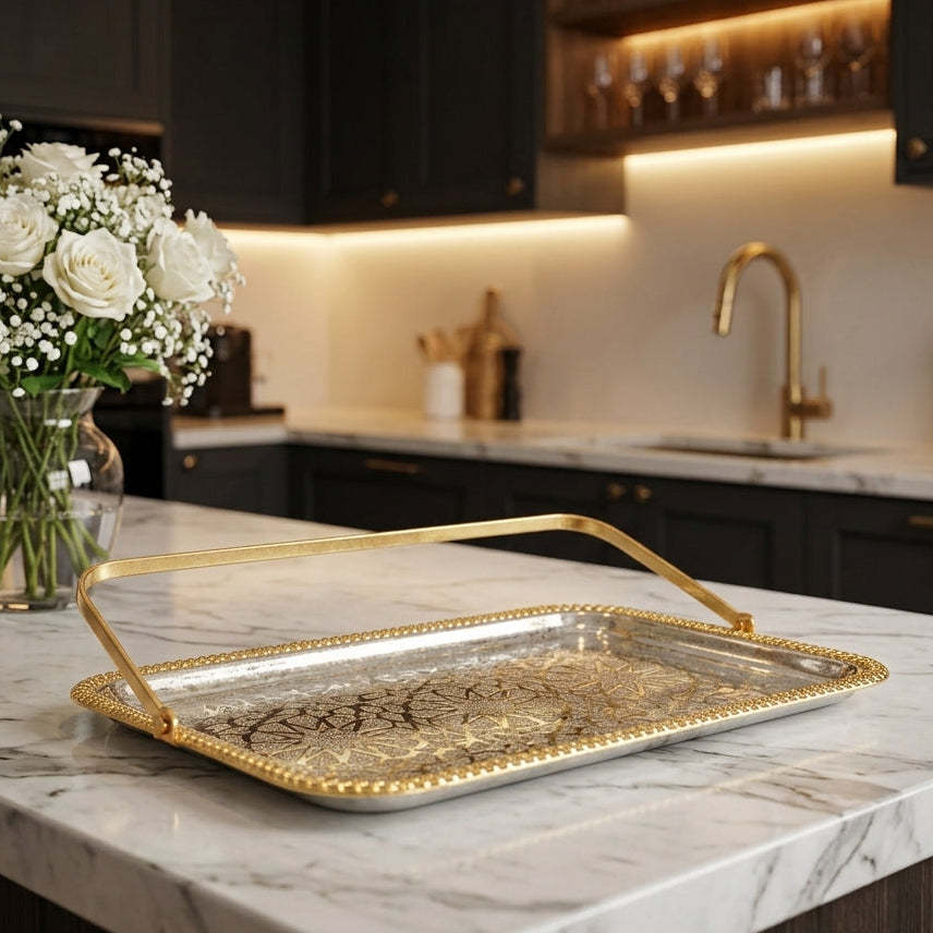 Luxury gold accent steel serving tray placed on a white marble kitchen island counter.