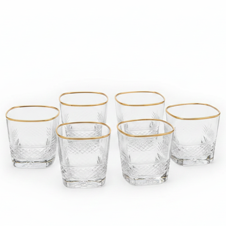 Luxury gold rim crystal glass tumbler set with a stainless steel holder on a dining table