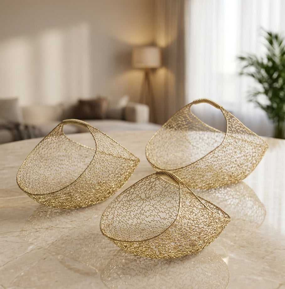 Luxury 3-piece gold wire mesh decorative basket set arranged on a marble table