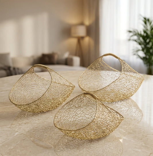 Luxury 3-piece gold wire mesh decorative basket set arranged on a marble table
