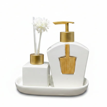 Luxury white ceramic liquid soap dispenser and matching diffuser bottle on a marble vanity tray.