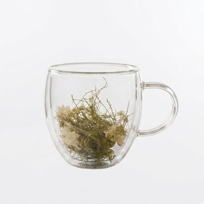 Front view of Meadow Bloom 250ml double wall glass coffee mug with real dried flowers inside.