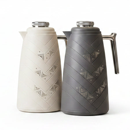 Mixff 1 Litre vacuum flasks in cream white and charcoal grey displayed on a marble kitchen counter