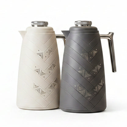 Mixff 1 Litre vacuum flasks in cream white and charcoal grey displayed on a marble kitchen counter