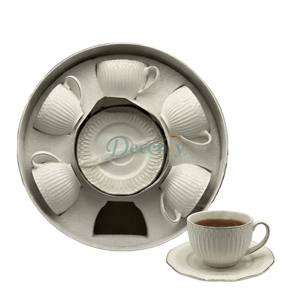 Elegant textured tea cup filled with milk tea resting on its matching saucer.