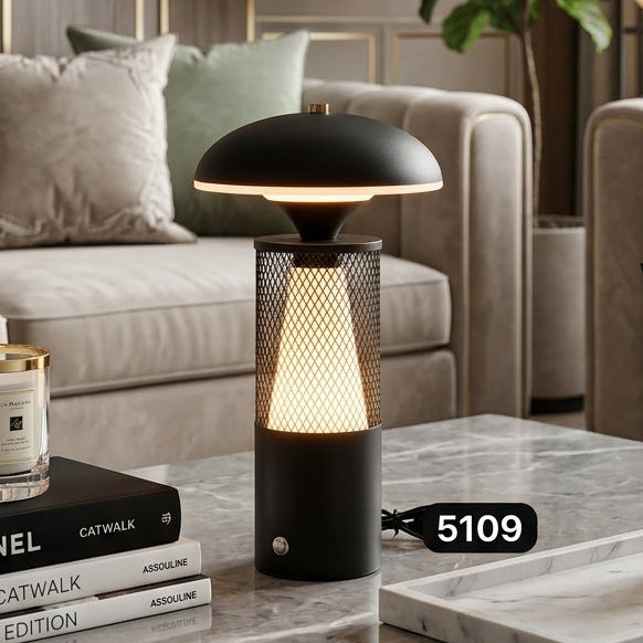Black modern cordless LED table lamp with a dome shade on a marble living room table