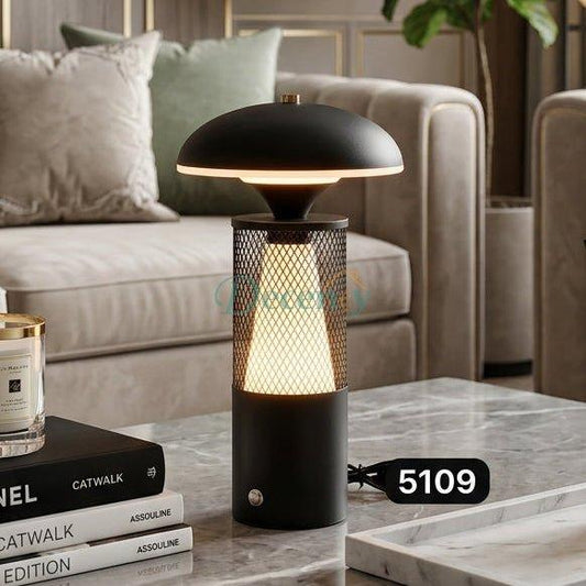 Black modern cordless LED table lamp with a dome shade on a marble living room table