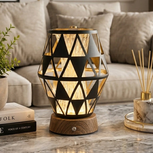 Modern geometric black metal table lamp on a marble coffee table in a living room