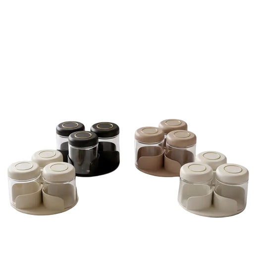 Close-up of glass spice jars with beige airtight lids sitting on a rotating base holder