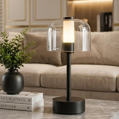Modern white glass dome LED table lamp illuminated on a coffee table with book