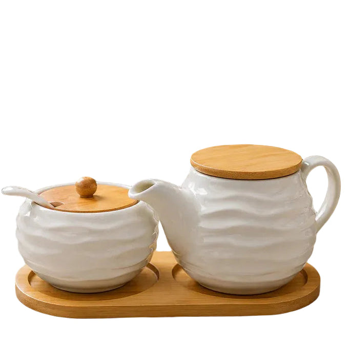 Nordic wave ceramic tea and storage jar set with a natural bamboo tray on a kitchen counter