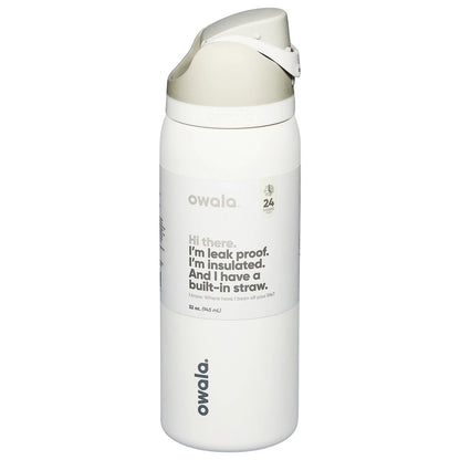 Owala FreeSip 32 oz insulated stainless steel water bottle in Shy Marshmallow color standing on marble kitchen counter.