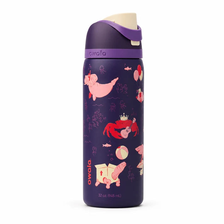 Owala FreeSip Party Animal 32oz purple insulated water bottle standing on a marble kitchen island.
