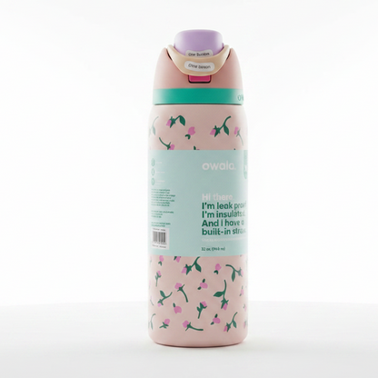 Owala insulated water bottle in Rosy Dreams design standing on a marble countertop