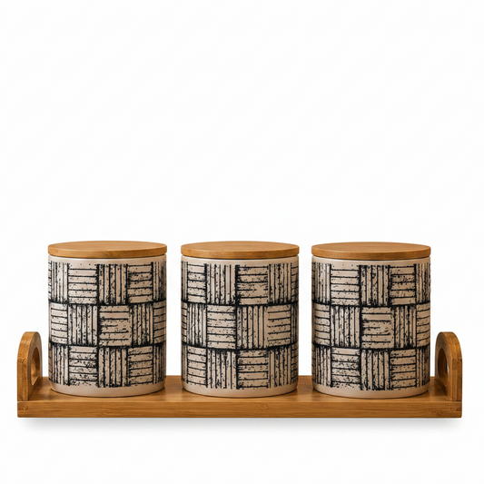 Three plaid pattern ceramic kitchen storage canisters arranged neatly on a wooden tray.
